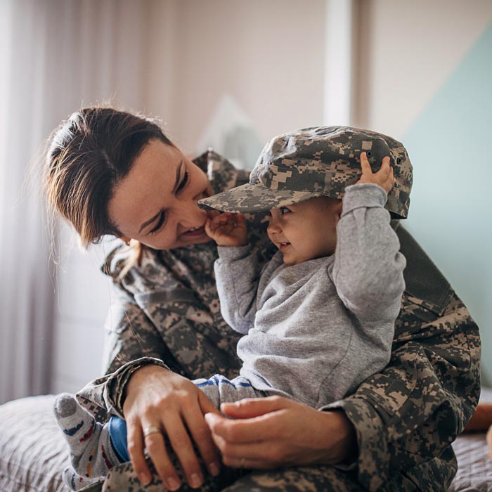female veteran holding baby son